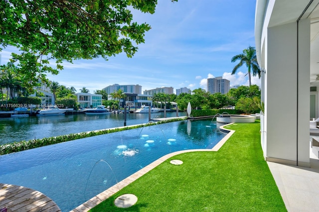 view of pool featuring a city view, a pool with connected hot tub, a yard, and a water view