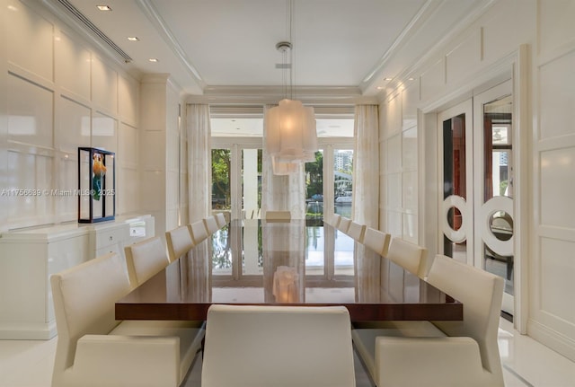 dining room with a decorative wall, recessed lighting, french doors, and ornamental molding