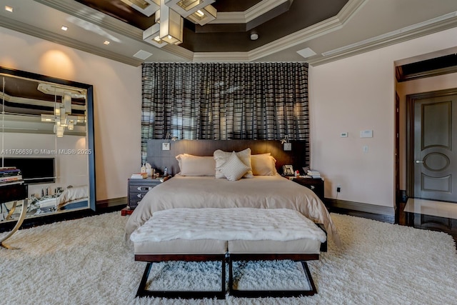 bedroom with a tray ceiling, baseboards, and ornamental molding