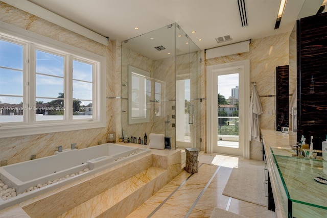 bathroom featuring plenty of natural light, visible vents, a stall shower, and a tub with jets