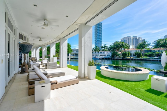 view of patio / terrace featuring a ceiling fan and a water view