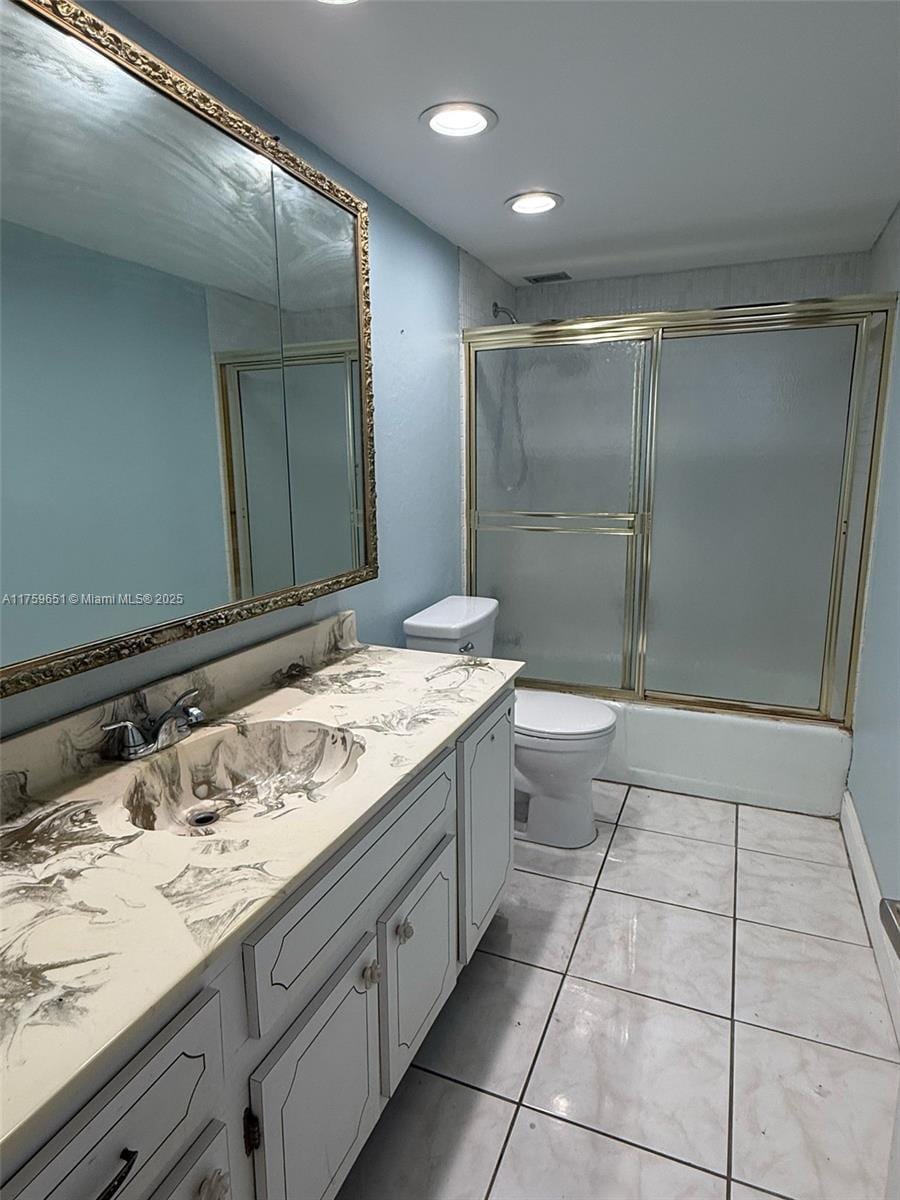 full bathroom featuring recessed lighting, vanity, toilet, and shower / bath combination with glass door