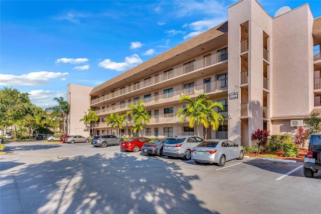 view of building exterior featuring uncovered parking