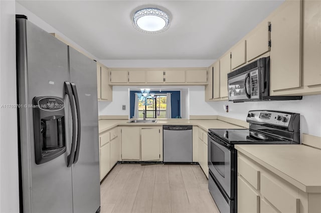 kitchen featuring light countertops, cream cabinetry, and appliances with stainless steel finishes