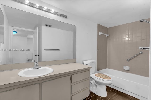 full bath featuring vanity, visible vents, wood finish floors,  shower combination, and toilet