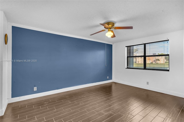 unfurnished room featuring ceiling fan, baseboards, a textured ceiling, and wood finished floors