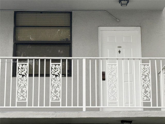 property entrance with stucco siding