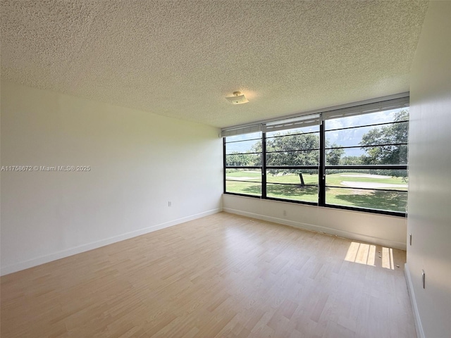1504 S Whitehall Dr Unit 206, Davie, FL 33324 - unfurnished room featuring a textured ceiling and wood finished floors
