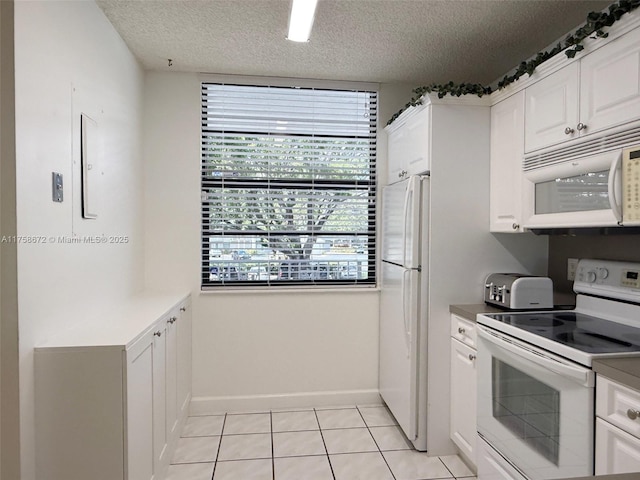 1504 S Whitehall Dr Unit 206, Davie, FL 33324 - kitchen featuring white appliances, white cabinets, a textured ceiling, and light tile patterned flooring