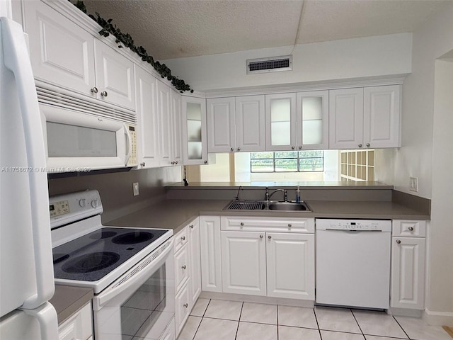 1504 S Whitehall Dr Unit 206, Davie, FL 33324 - kitchen featuring white appliances, light tile patterned floors, glass insert cabinets, and white cabinetry