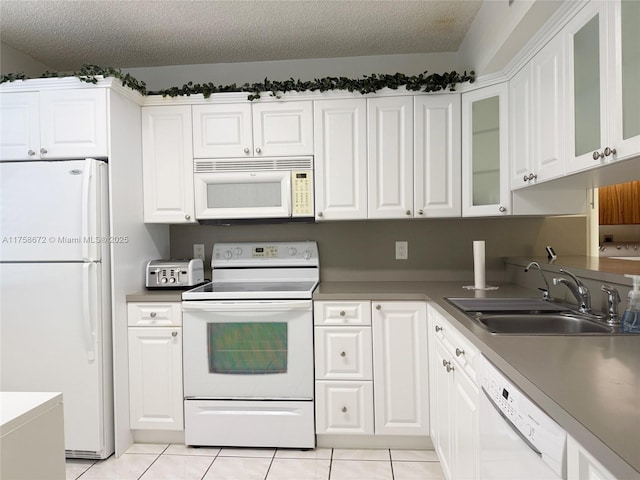 1504 S Whitehall Dr Unit 206, Davie, FL 33324 - kitchen with white appliances, light tile patterned flooring, white cabinets, a textured ceiling, and glass insert cabinets
