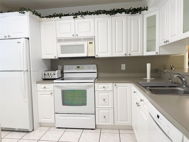 1504 S Whitehall Dr Unit 206, Davie, FL 33324 - kitchen featuring white appliances, light tile patterned flooring, white cabinets, and glass insert cabinets