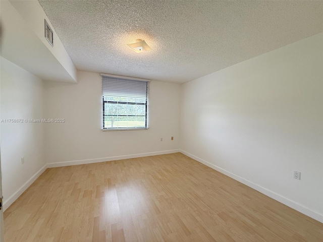 1504 S Whitehall Dr Unit 206, Davie, FL 33324 - spare room with light wood finished floors and a textured ceiling