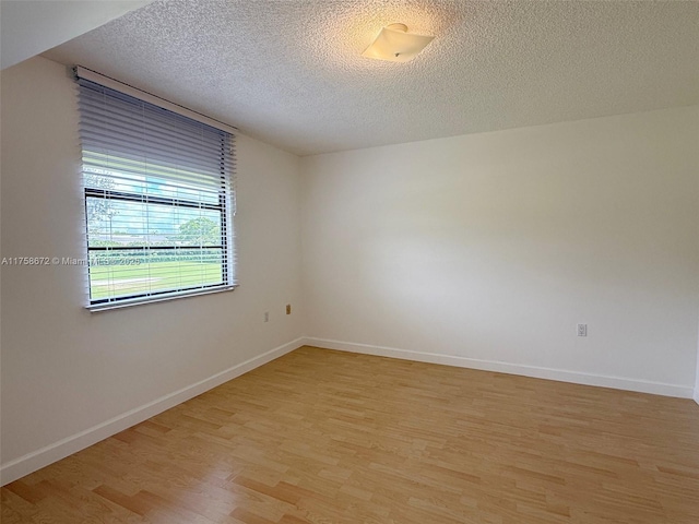 1504 S Whitehall Dr Unit 206, Davie, FL 33324 - unfurnished room with light wood finished floors and a textured ceiling