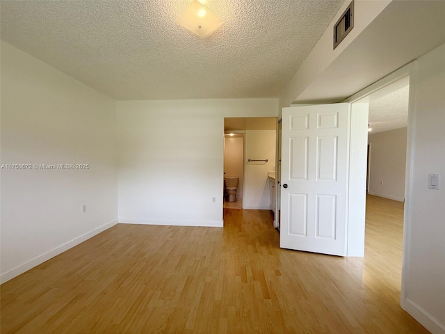 1504 S Whitehall Dr Unit 206, Davie, FL 33324 - empty room featuring a textured ceiling and light wood-style flooring