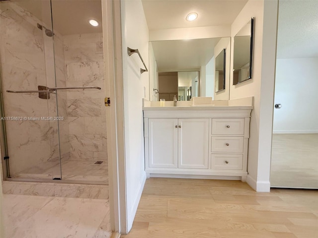 1504 S Whitehall Dr Unit 206, Davie, FL 33324 - bathroom featuring a marble finish shower, vanity, wood finished floors, and recessed lighting