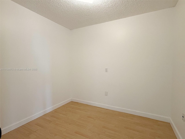 1504 S Whitehall Dr Unit 206, Davie, FL 33324 - unfurnished room with light wood finished floors and a textured ceiling