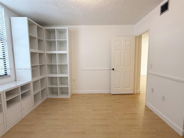 1504 S Whitehall Dr Unit 206, Davie, FL 33324 - unfurnished room featuring light wood finished floors and a textured ceiling