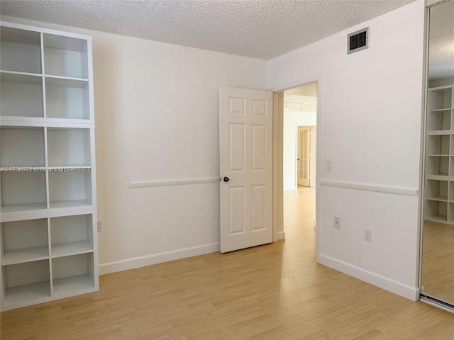 1504 S Whitehall Dr Unit 206, Davie, FL 33324 - unfurnished bedroom with wood finished floors and a textured ceiling