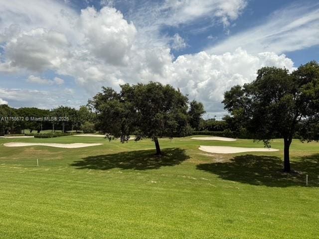 1504 S Whitehall Dr Unit 206, Davie, FL 33324 - view of home's community with view of golf course, a lawn, and view of wooded area
