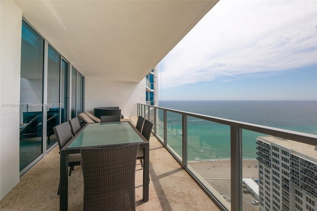 balcony featuring a beach view and a water view