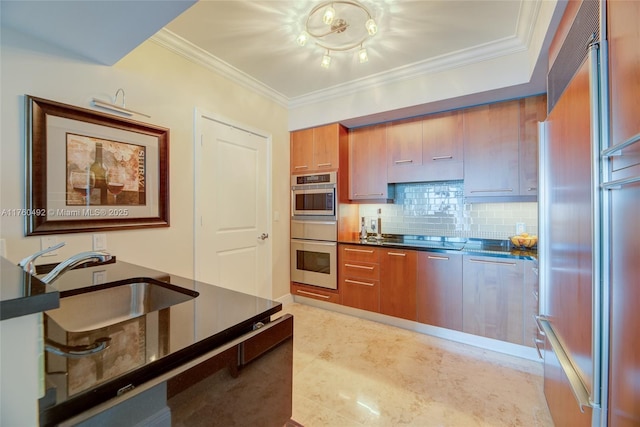 kitchen featuring dark countertops, stainless steel appliances, crown molding, and a sink