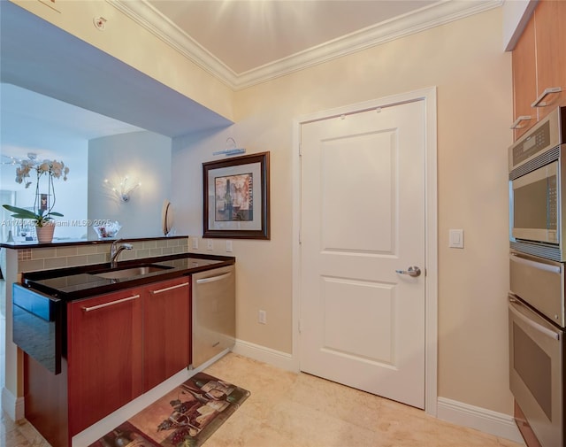 kitchen with backsplash, baseboards, ornamental molding, appliances with stainless steel finishes, and a sink