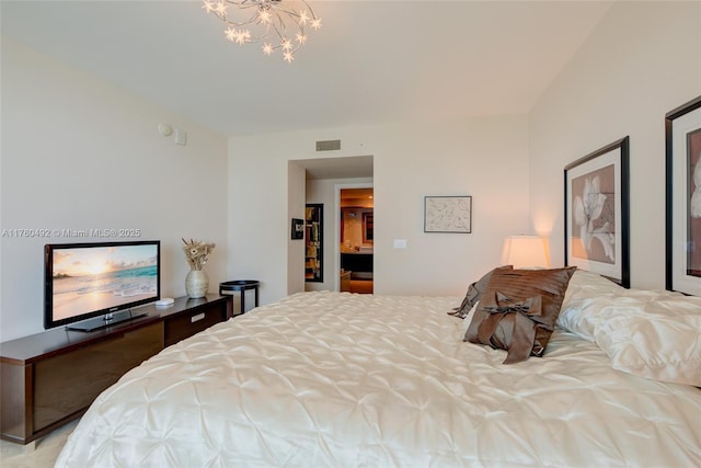 bedroom featuring visible vents and a chandelier