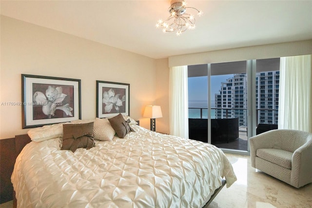 bedroom with an inviting chandelier and access to exterior