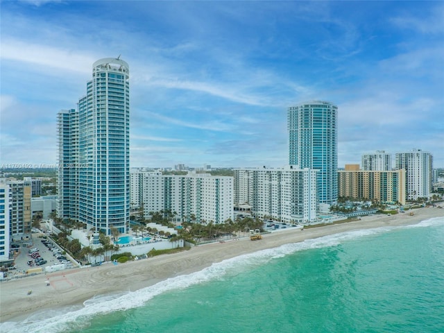 aerial view with a view of city, a view of the beach, and a water view