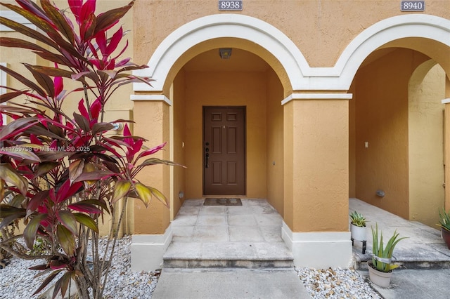 entrance to property with stucco siding