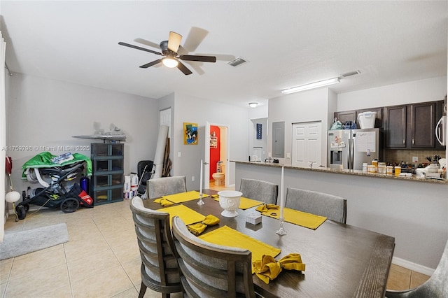 dining area featuring visible vents, a ceiling fan, and light tile patterned floors