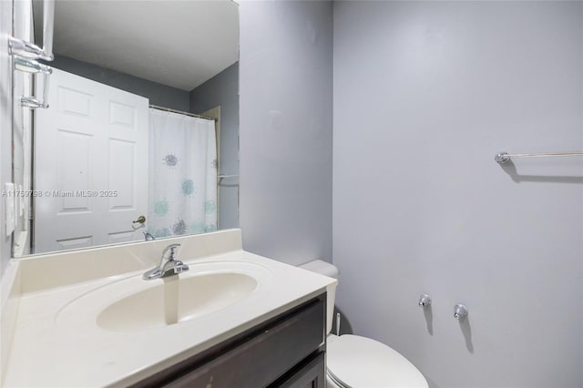 bathroom with toilet and vanity