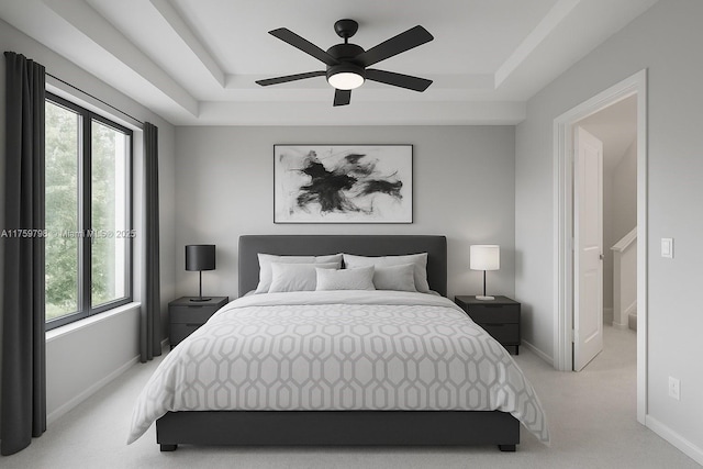 bedroom with a ceiling fan, baseboards, light carpet, and a tray ceiling
