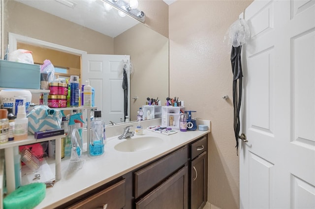 bathroom with vanity and a textured wall