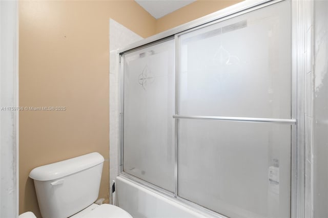 full bathroom with shower / bath combination with glass door and toilet