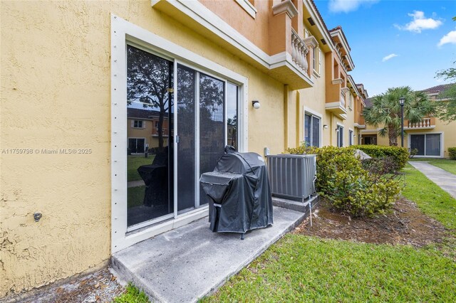 exterior space featuring central AC and a grill