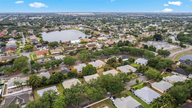 drone / aerial view featuring a water view and a residential view