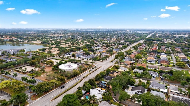 drone / aerial view featuring a residential view and a water view