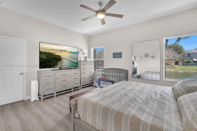 bedroom with light wood-style flooring and ceiling fan