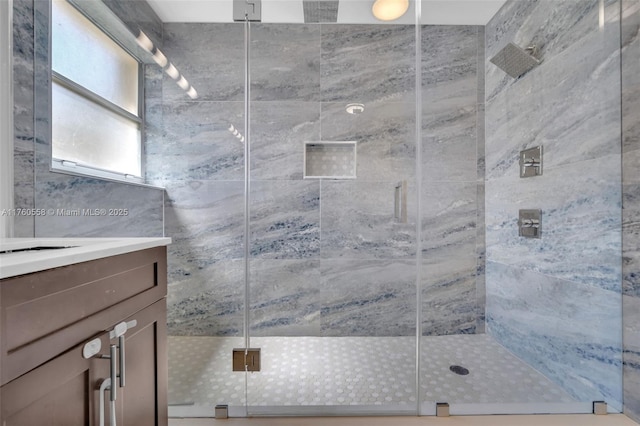 bathroom featuring a stall shower and vanity