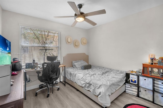 bedroom featuring light wood-type flooring and a ceiling fan