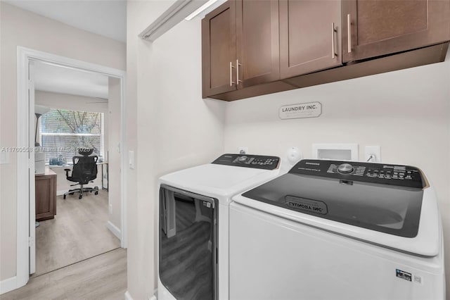 washroom with baseboards, cabinet space, independent washer and dryer, and light wood-type flooring