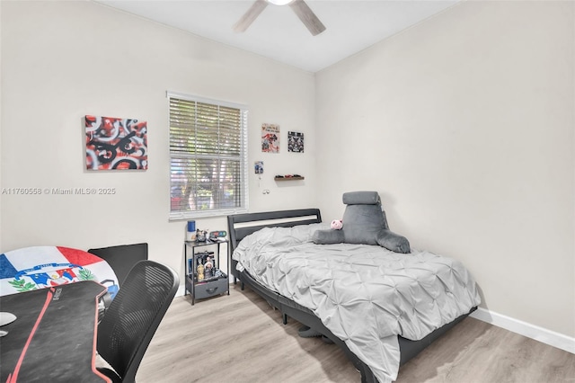 bedroom with ceiling fan, baseboards, and wood finished floors