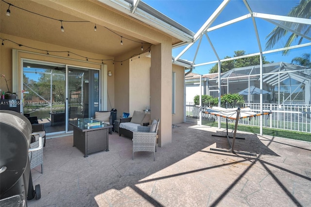 view of patio / terrace with glass enclosure and an outdoor living space