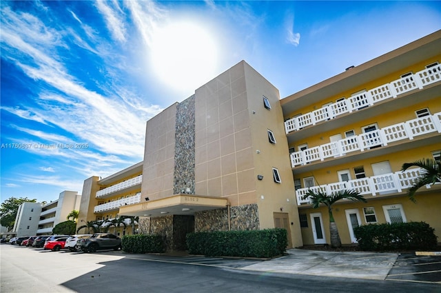 view of building exterior with uncovered parking