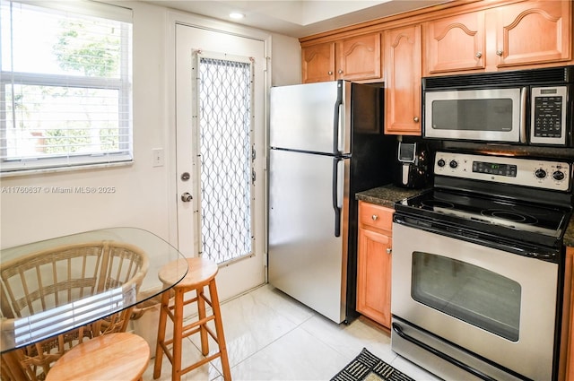 kitchen featuring dark countertops and appliances with stainless steel finishes