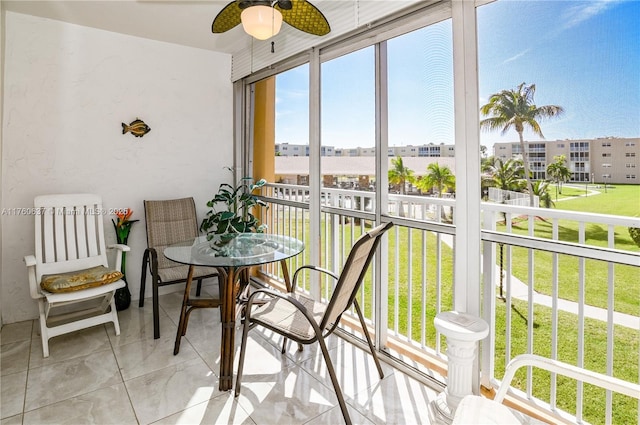 sunroom / solarium featuring ceiling fan