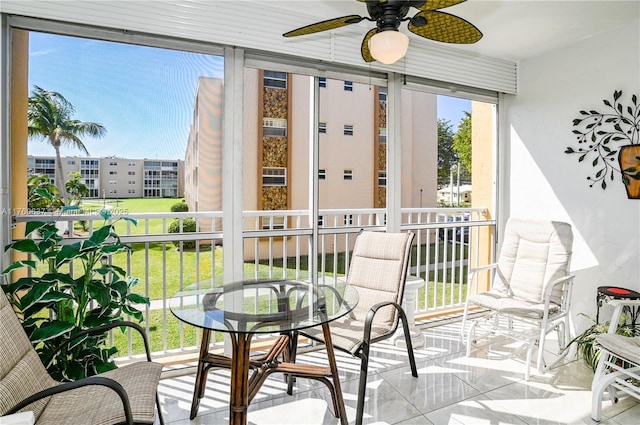 sunroom / solarium featuring ceiling fan