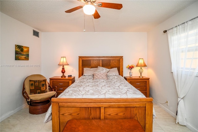 bedroom featuring baseboards, visible vents, a textured ceiling, and ceiling fan